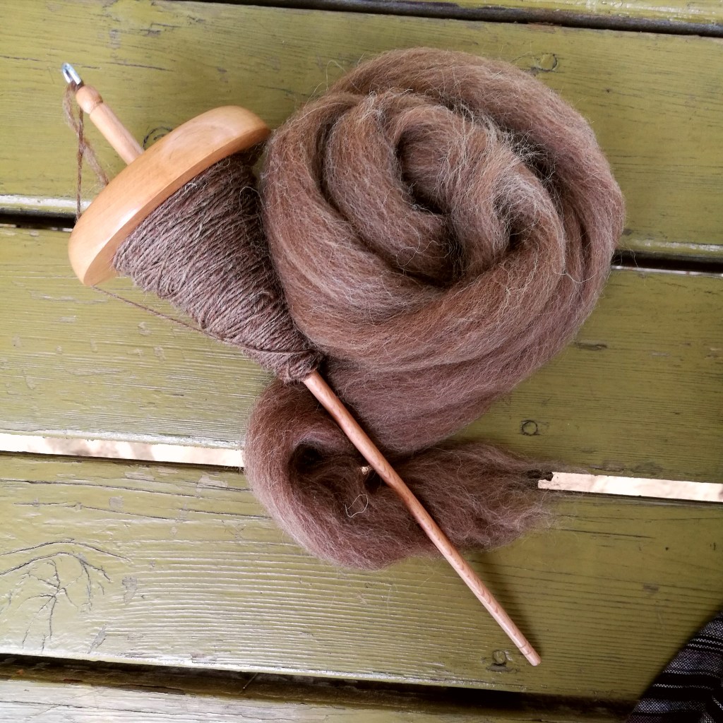 A modern top whorl drop spindle.
Photo credit: Nicole DeRushie, 2022